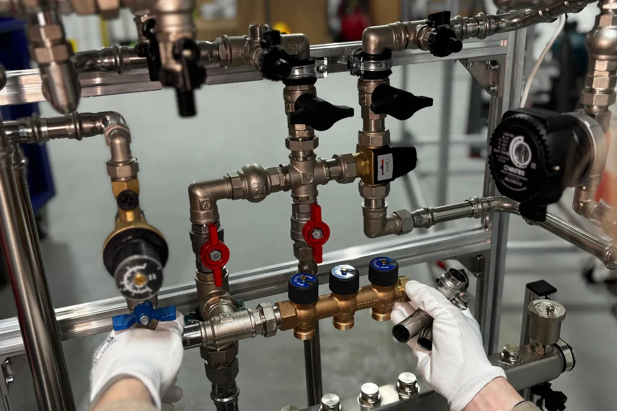 Engineer testing valves on a heating system