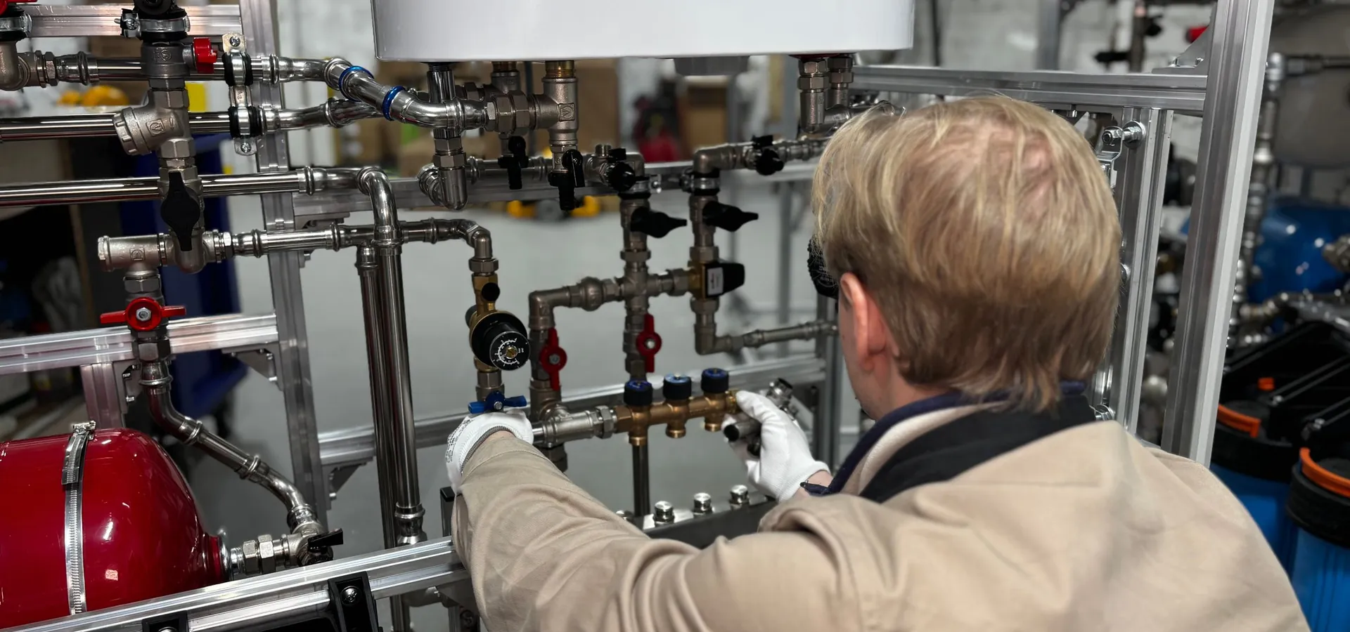 Engineer adjusting valves on a heating manifold