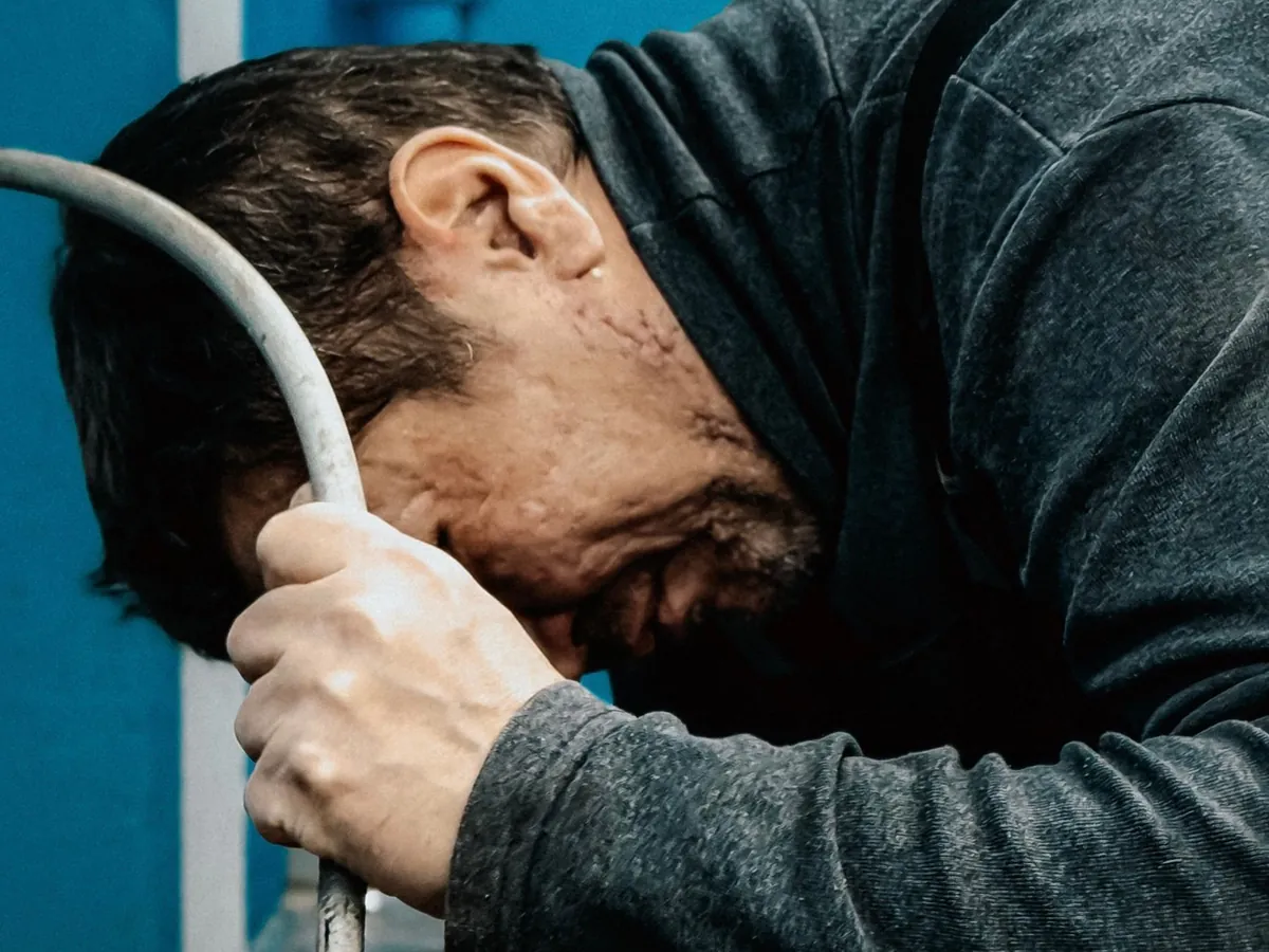 Plumber bent over a pump hose during an emergency call