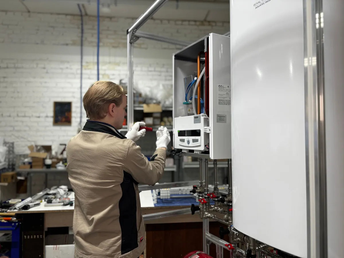 Engineer working at a newly fitted wall boiler