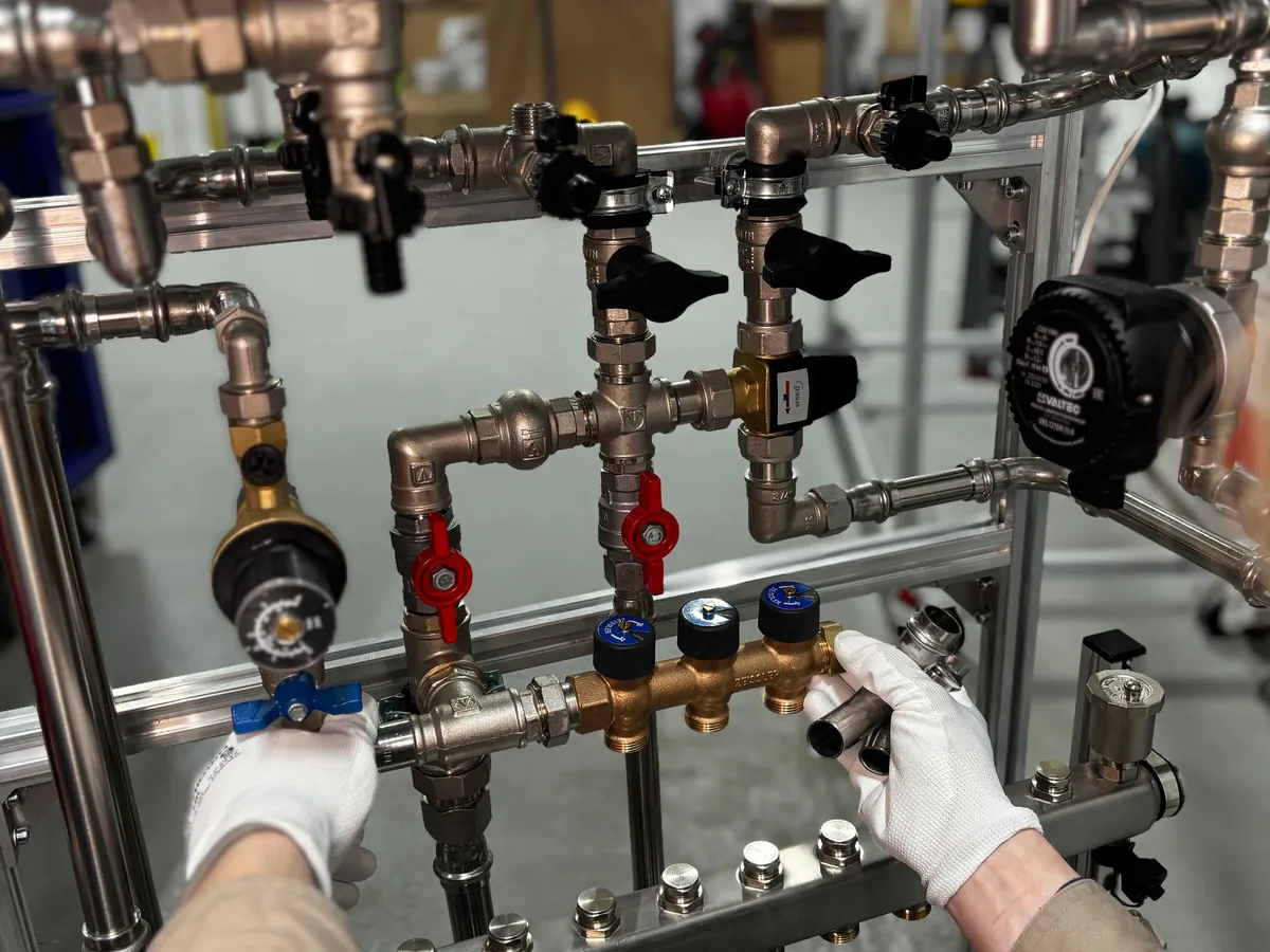 Engineer testing valves on a heating system