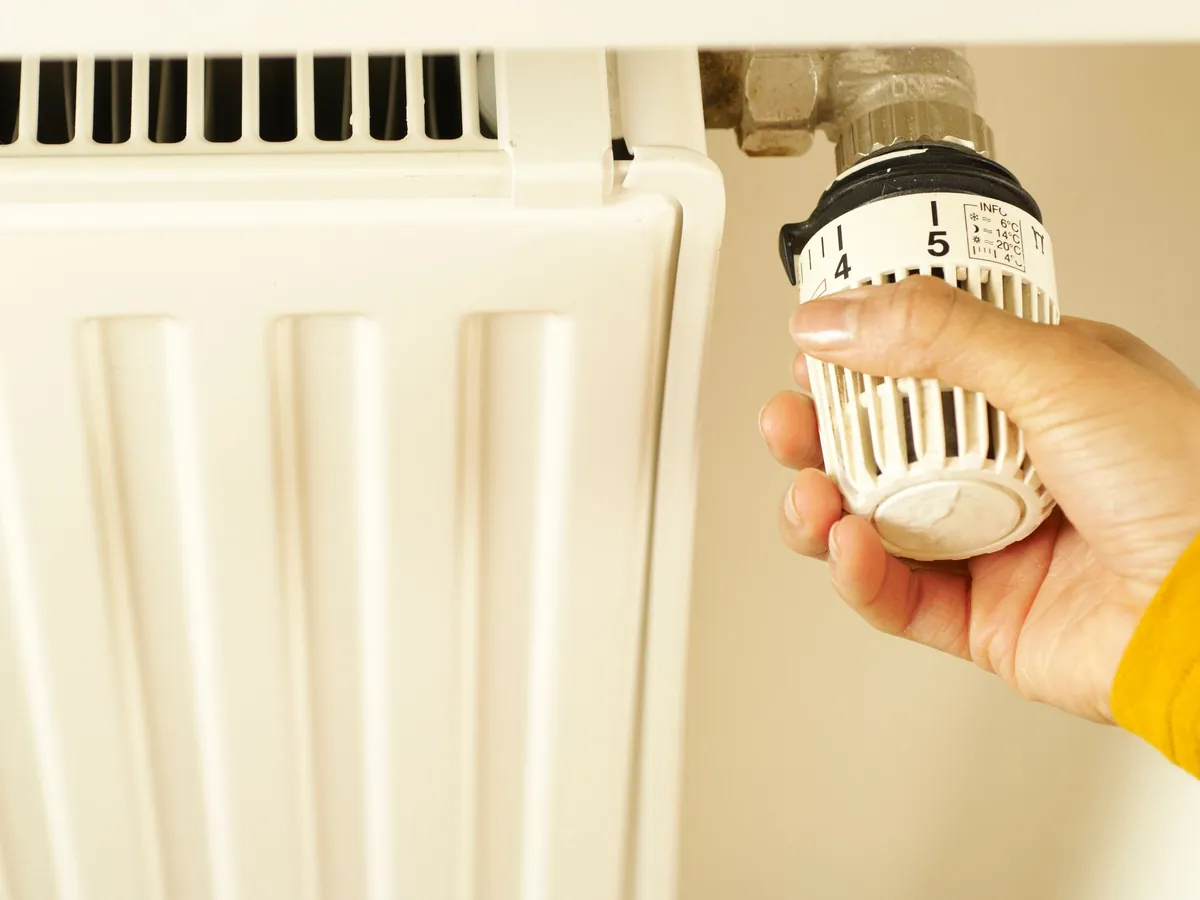 Hand adjusting a thermostatic radiator valve