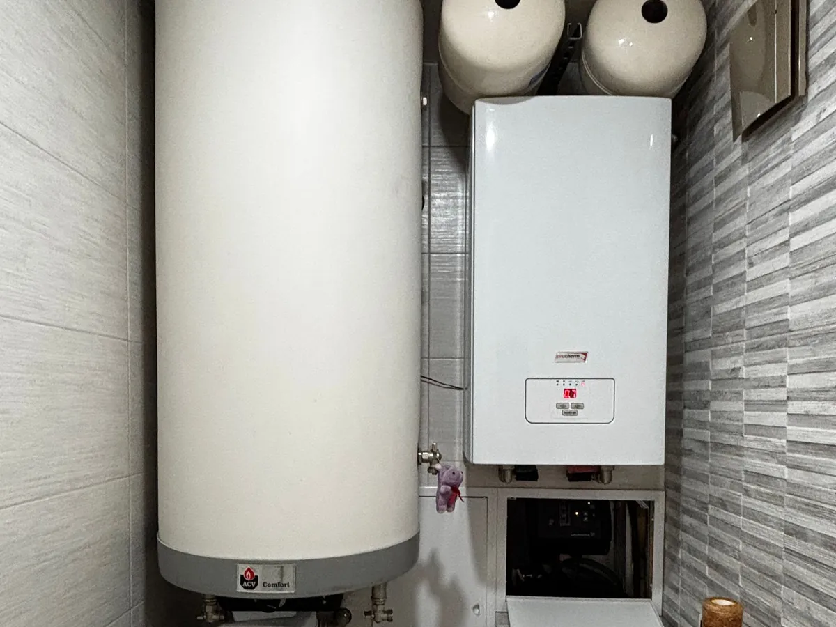 Wall boiler beside a hot water cylinder