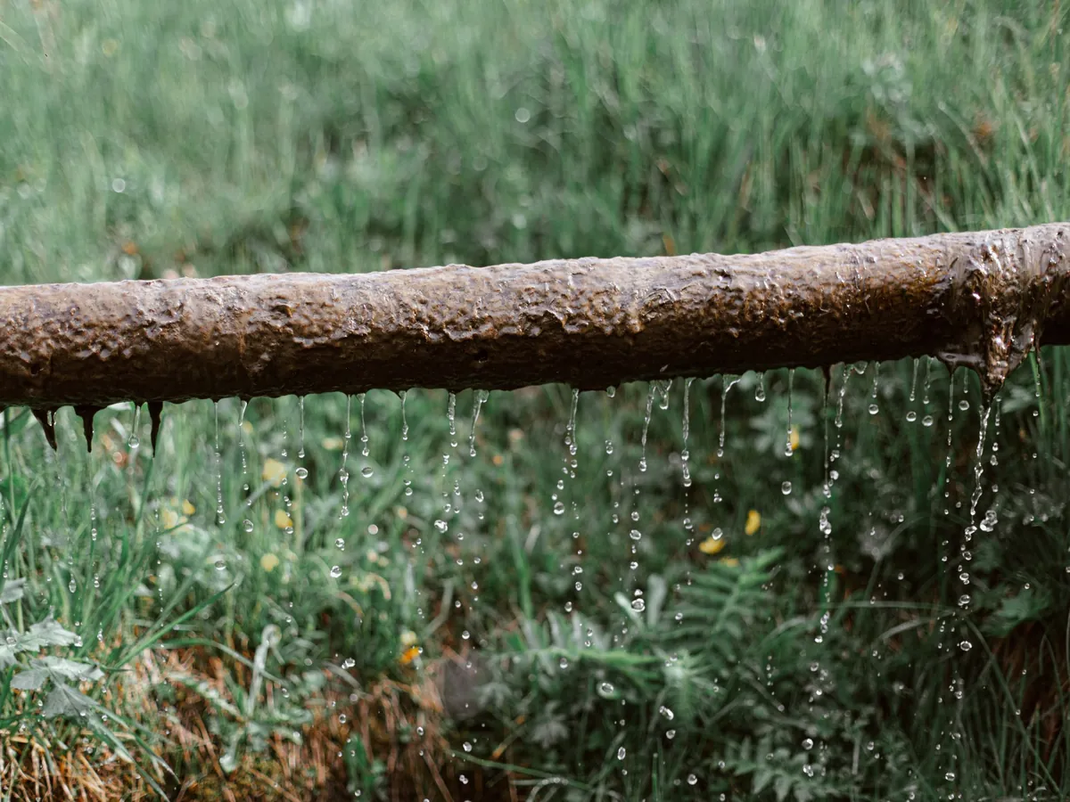 Water dripping along the length of a leaking pipe