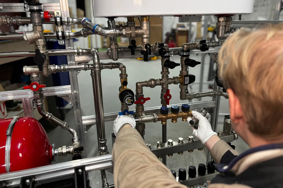Engineer checking pressure gauges on a manifold