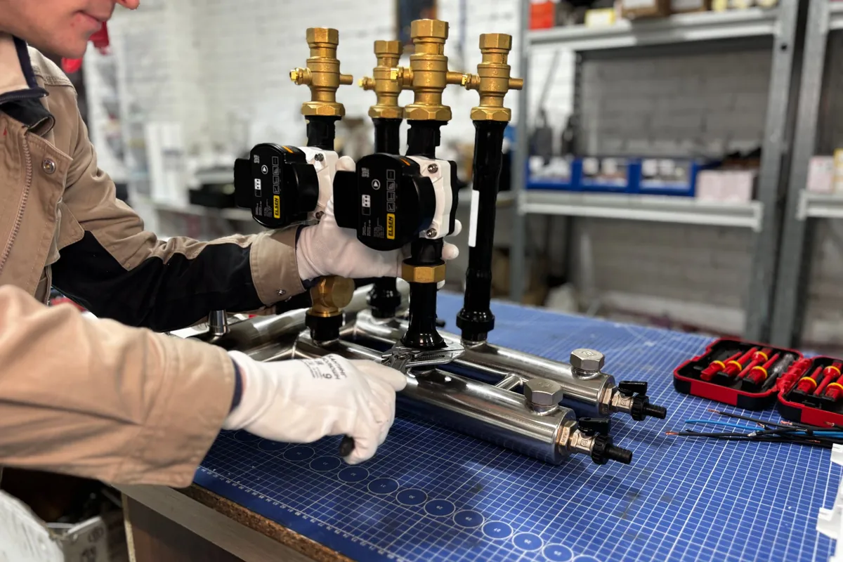 Engineer assembling a pump group on a bench